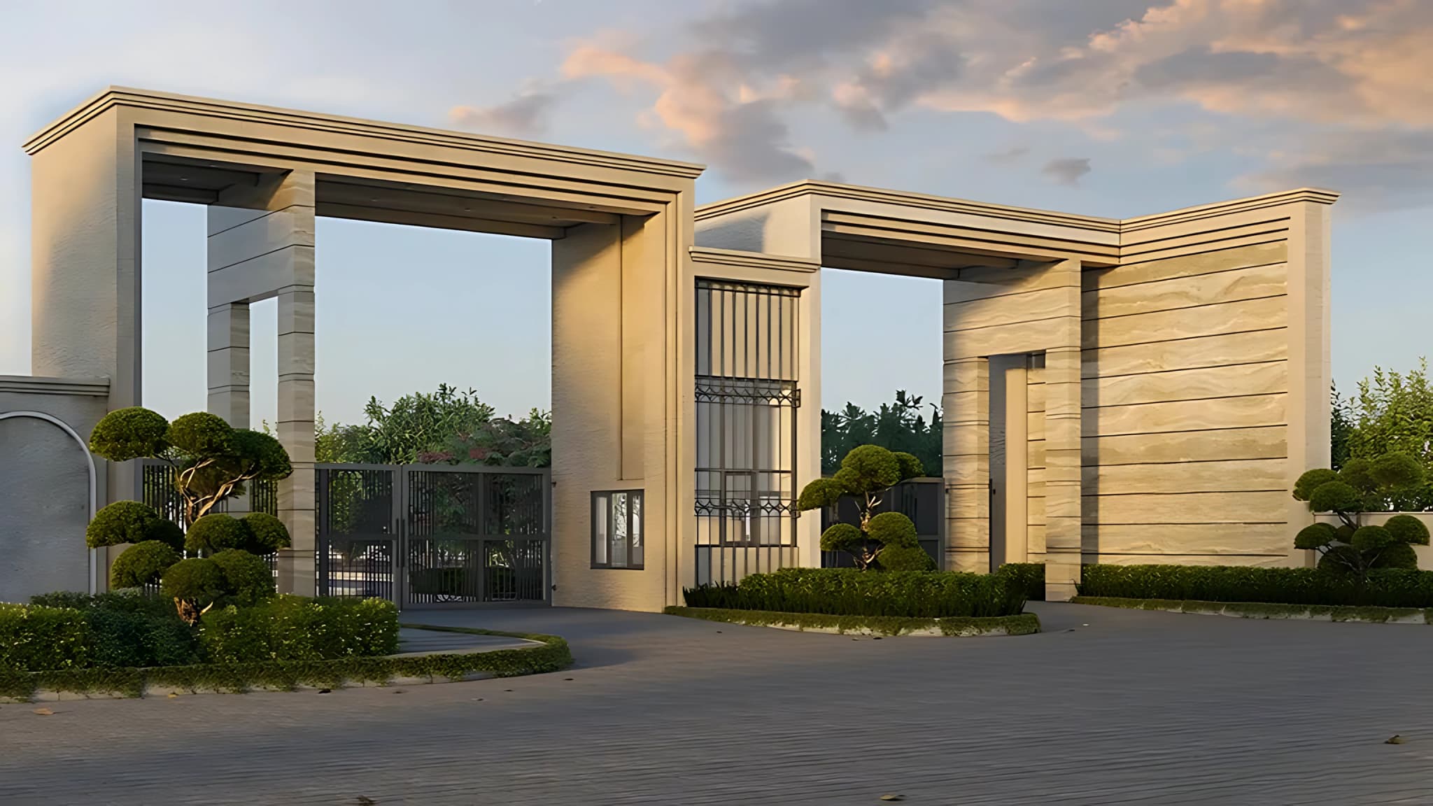 Grand entrance gate of Godrej Evora Estate premium residential township project under a sunset sky