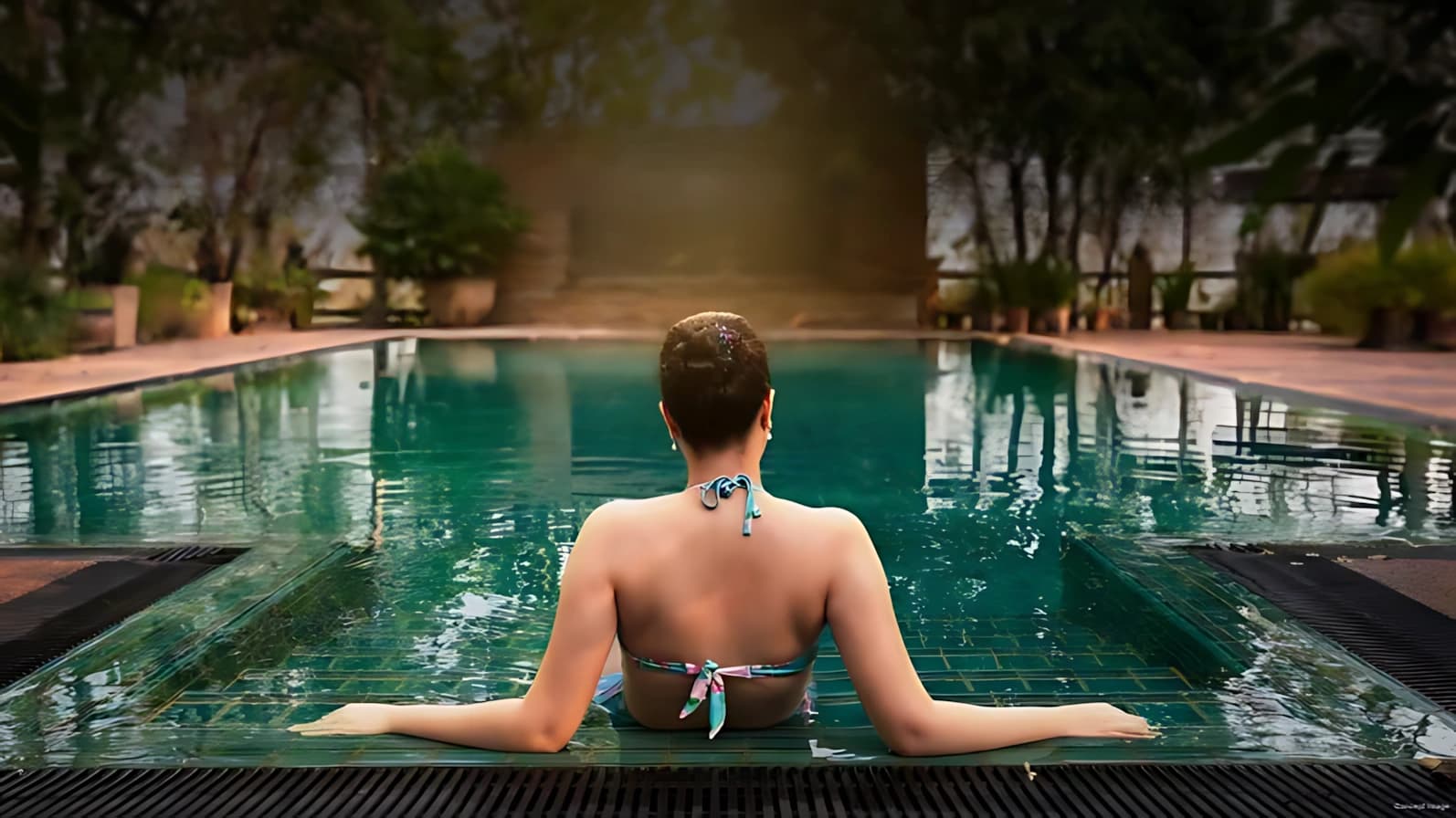 Luxury swimming pool surrounded by lush green landscapes at Sobha Aranya